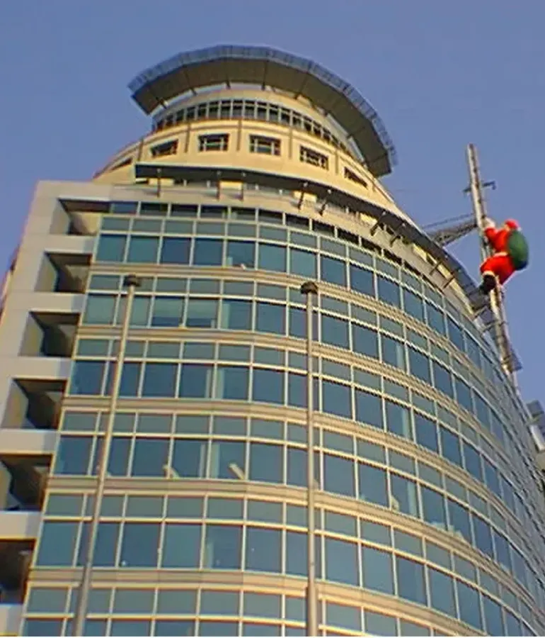 Viejo Pascuero suspendido en torre de oficinas